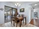 Casual dining area with wood table and chairs, view to pool at 1954 Arkansas Ave, Englewood, FL 34224