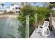 Relaxing waterfront dock with rocking chair at 1954 Arkansas Ave, Englewood, FL 34224