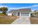 White house with gray screened garage and landscaped yard at 1954 Arkansas Ave, Englewood, FL 34224