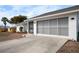 White house with gray screened garage door and concrete driveway at 1954 Arkansas Ave, Englewood, FL 34224