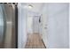 Home hallway with tile flooring, neutral walls and access to kitchen and other rooms at 1954 Arkansas Ave, Englewood, FL 34224