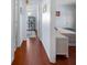 Light and bright hallway with wood floors connecting bedrooms at 1954 Arkansas Ave, Englewood, FL 34224