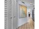 Bright hallway with tile floors, white closet doors and nautical map decor at 1954 Arkansas Ave, Englewood, FL 34224