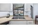 Kitchen with stainless steel sink and view of canal from window at 1954 Arkansas Ave, Englewood, FL 34224