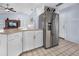 Kitchen with stainless steel refrigerator, white cabinets and granite countertops at 1954 Arkansas Ave, Englewood, FL 34224