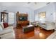 Living room with hardwood floors, neutral walls, and comfy seating at 1954 Arkansas Ave, Englewood, FL 34224