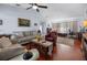 Bright living room with hardwood floors, comfortable seating, and a fireplace at 1954 Arkansas Ave, Englewood, FL 34224