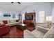 Living room with hardwood floors, neutral walls, and comfy seating at 1954 Arkansas Ave, Englewood, FL 34224