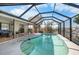 Enclosed pool area with a covered patio and canal view at 1954 Arkansas Ave, Englewood, FL 34224