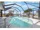 Enjoy this screened in pool and patio with canal access at 1954 Arkansas Ave, Englewood, FL 34224