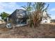 Screened-in pool area with tropical plants at 1954 Arkansas Ave, Englewood, FL 34224