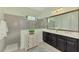 Elegant bathroom with double vanity and a large walk-in shower at 21228 Sandal Foot Dr, Venice, FL 34293