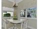 Bright dining room with white table and chairs, featuring stylish window treatments at 21228 Sandal Foot Dr, Venice, FL 34293