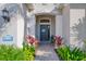 Front entrance with a dark-grey door and decorative plants at 21228 Sandal Foot Dr, Venice, FL 34293