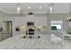 Modern kitchen with white cabinets, granite countertops and breakfast bar at 21228 Sandal Foot Dr, Venice, FL 34293