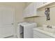 Laundry room with washer, dryer, sink, and ample cabinets at 21228 Sandal Foot Dr, Venice, FL 34293