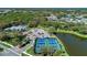 Aerial view of community tennis courts near a lake at 21228 Sandal Foot Dr, Venice, FL 34293