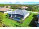 Home with pool and screened enclosure; located in a quiet neighborhood with lush landscaping at 22 Windward Rd, Placida, FL 33946