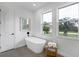 Relaxing bathroom with freestanding tub, large windows, and neutral colors at 22 Windward Rd, Placida, FL 33946