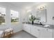 Bathroom with double vanity, granite countertop, and large mirror at 22 Windward Rd, Placida, FL 33946