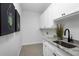 Bright laundry room with white cabinets and granite countertop at 22 Windward Rd, Placida, FL 33946