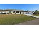 Single-story home with a driveway and landscaped lawn at 23046 Foote Ave, Port Charlotte, FL 33952