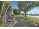 Landscaped backyard with lake view and large tree at 2365 Malaya Ct, Punta Gorda, FL 33983