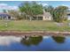 Lake view from home's backyard, lush grass and trees at 2365 Malaya Ct, Punta Gorda, FL 33983