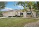 Tan house with stone accents, mature trees, and a well-manicured lawn at 2365 Malaya Ct, Punta Gorda, FL 33983