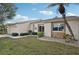 House exterior showcasing a tan color scheme, stone accents, and landscaping at 2365 Malaya Ct, Punta Gorda, FL 33983