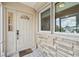 Light beige front door with a decorative window and stone accents at 2365 Malaya Ct, Punta Gorda, FL 33983