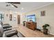 Living room with hardwood floors, gray reclining sofas, and a flat-screen TV at 2365 Malaya Ct, Punta Gorda, FL 33983