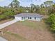 New construction home with a large yard and driveway at 2462 Ensenada Ln, North Port, FL 34286