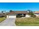 Single story home with attached garage and well manicured lawn at 2483 Dixon Ter, Port Charlotte, FL 33981