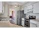 Kitchen boasts stainless steel appliances and white cabinets at 2483 Dixon Ter, Port Charlotte, FL 33981