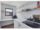 Laundry room with washer, dryer, and storage shelves at 2483 Dixon Ter, Port Charlotte, FL 33981