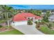 Aerial view of a single-Gathering home with red tile roof and landscaped yard at 26266 Barcelos Ct, Punta Gorda, FL 33983