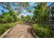 Landscaped backyard with stone pathway at 26266 Barcelos Ct, Punta Gorda, FL 33983