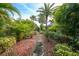 Circular stone pathway through tropical landscaping at 26266 Barcelos Ct, Punta Gorda, FL 33983