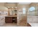 Elegant bathroom with granite vanity, tiled shower, and soaking tub at 26266 Barcelos Ct, Punta Gorda, FL 33983