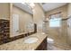 Bathroom boasts granite countertop and tiled shower/tub combo at 26266 Barcelos Ct, Punta Gorda, FL 33983