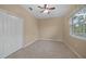 Bright bedroom with window, ceiling fan and closet at 26266 Barcelos Ct, Punta Gorda, FL 33983