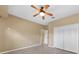 Spacious bedroom with ceiling fan and double door closet at 26266 Barcelos Ct, Punta Gorda, FL 33983