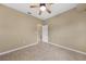 Bright bedroom featuring tile flooring and a ceiling fan at 26266 Barcelos Ct, Punta Gorda, FL 33983