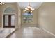 Bright dining room with chandelier, large window, and tiled floor at 26266 Barcelos Ct, Punta Gorda, FL 33983