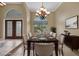 Virtually staged dining room with a dark wood table and neutral decor at 26266 Barcelos Ct, Punta Gorda, FL 33983