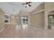 Bright living room with tile floors, fireplace, and sliding glass doors leading to pool at 26266 Barcelos Ct, Punta Gorda, FL 33983