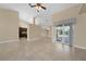 Bright living room with tile floors, fireplace, and sliding glass doors leading to pool at 26266 Barcelos Ct, Punta Gorda, FL 33983