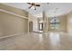 High ceiling living room with tile floors and fan at 26266 Barcelos Ct, Punta Gorda, FL 33983