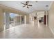 Bright living room with tile floors and views of the pool and kitchen at 26266 Barcelos Ct, Punta Gorda, FL 33983